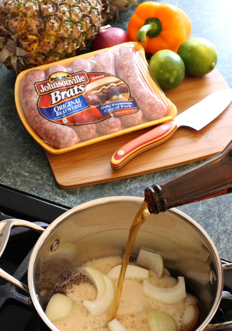 Bratwurst with Pineapple Tequila Salsa get boiled in beer and onions