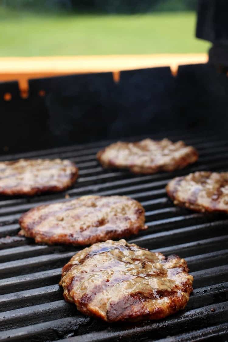 This French Onion Cheeseburger is dripping with gooey cheese and sweet caramelized onions. Serve on Texas toast for an extra flavor boost! hamburger patties on grill