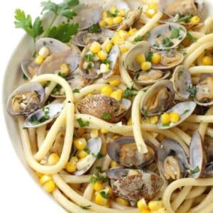 pasta recipe with fresh corn and clams in a bowl