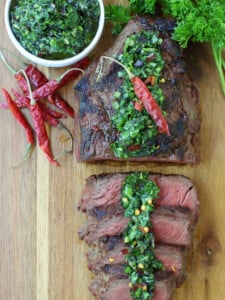 kale chimichurri sauce spooned over sliced steak