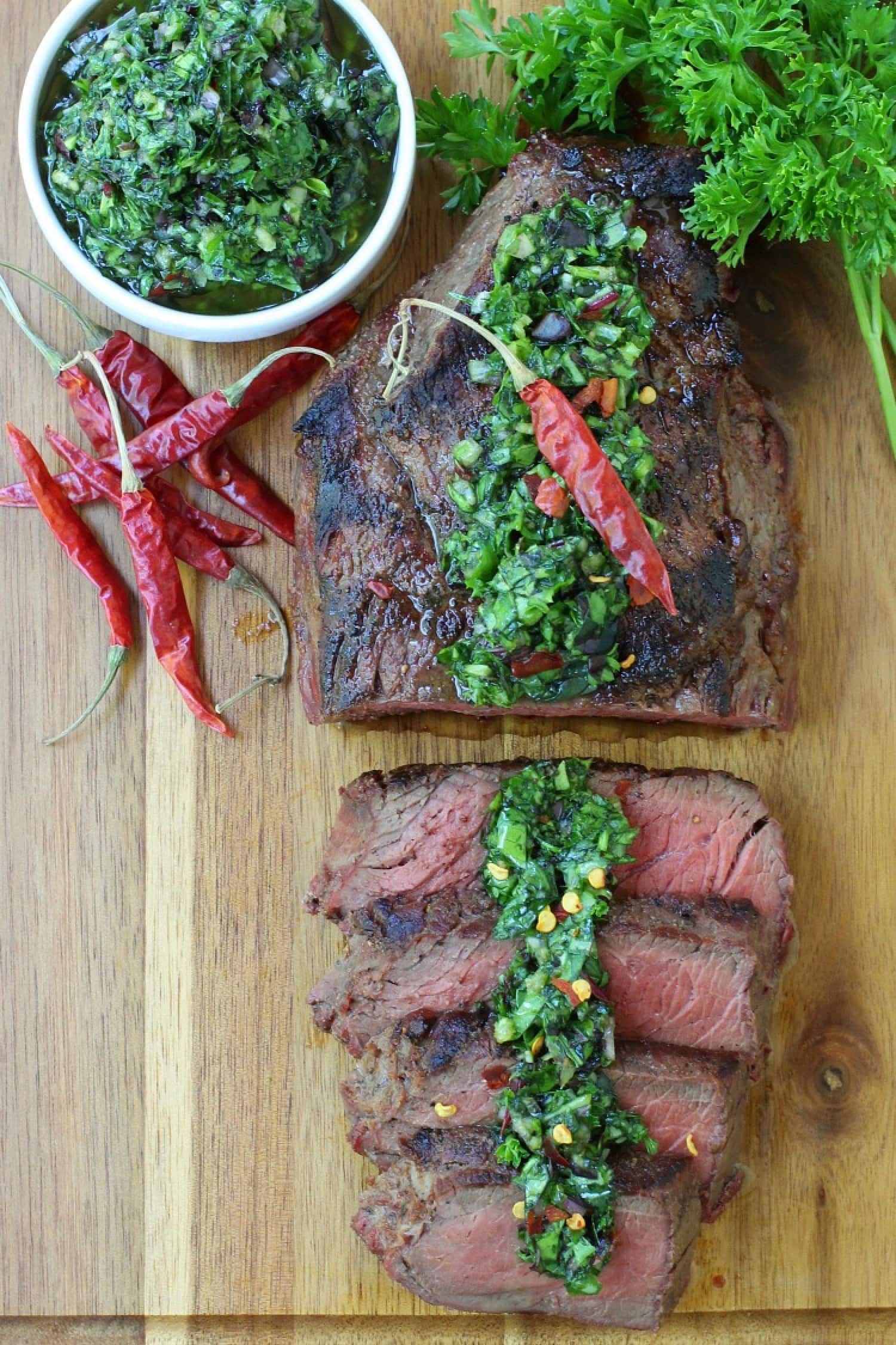 kale chimichurri sauce spooned over sliced steak