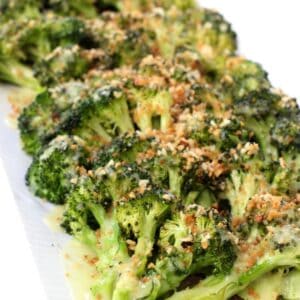 roasted broccoli with breadcrumbs and Hollandaise sauce on a platter