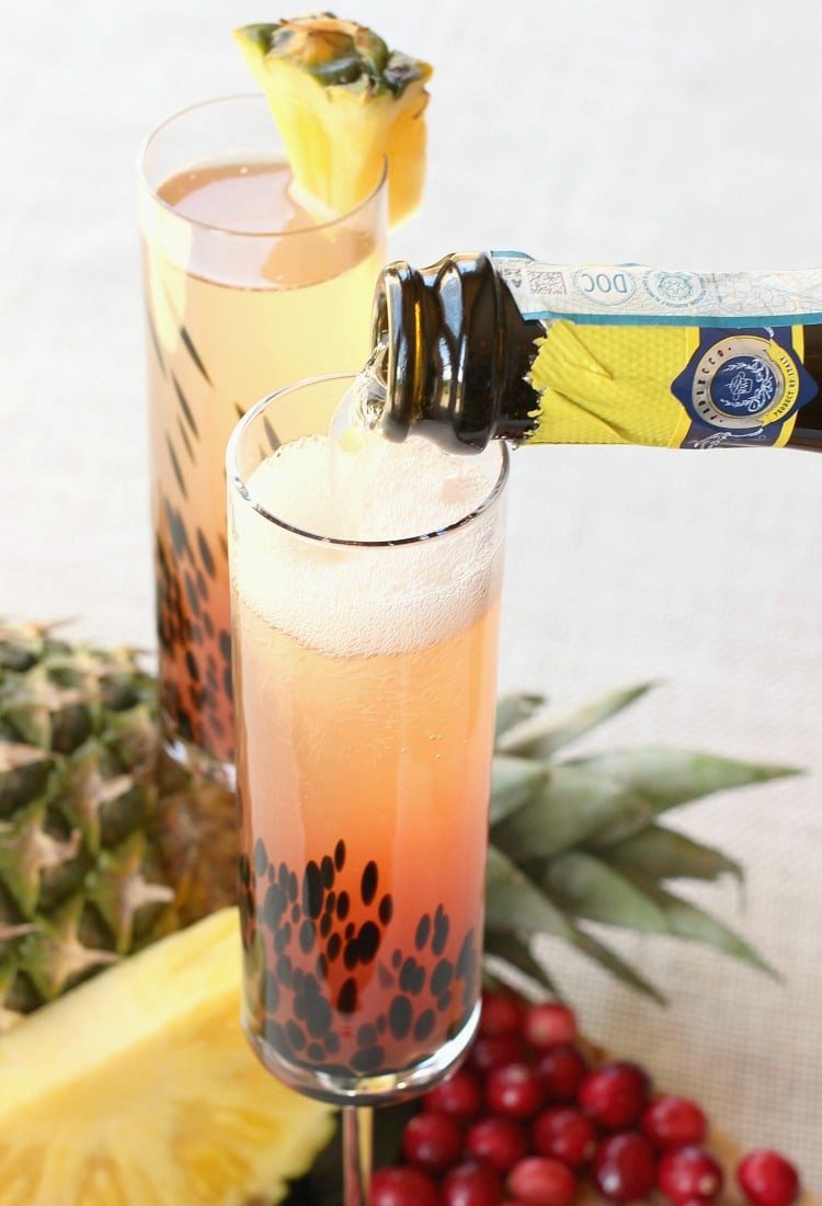 Island Champagne Cocktail is a champagne recipe with amaretto, orange juice and cranberry juice