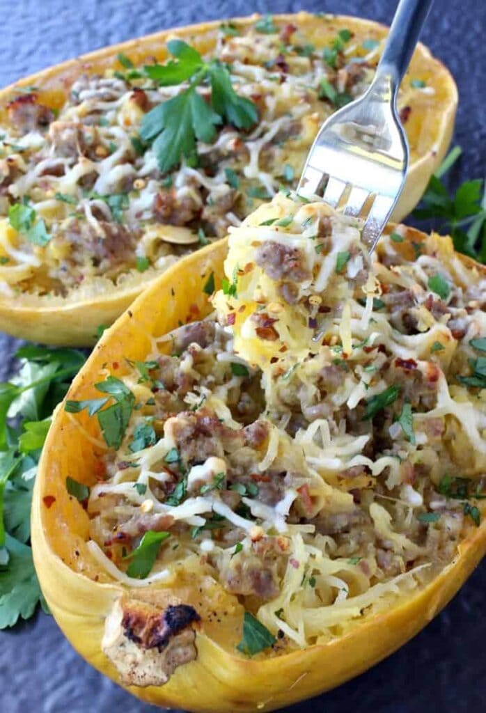 Sausage Spaghetti Squash with a fork taking a bite out