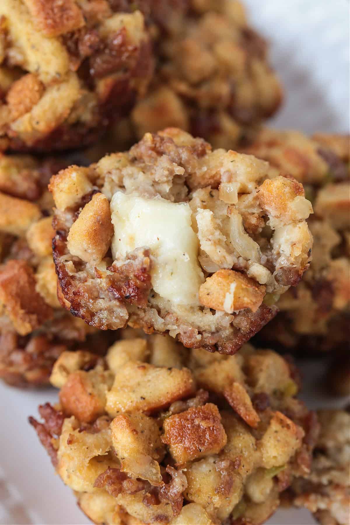 stuffing muffin cut in half with a cheese center