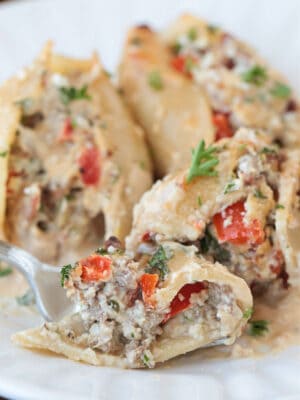 fork on a plate with a bite of cheesesteak stuffed shells
