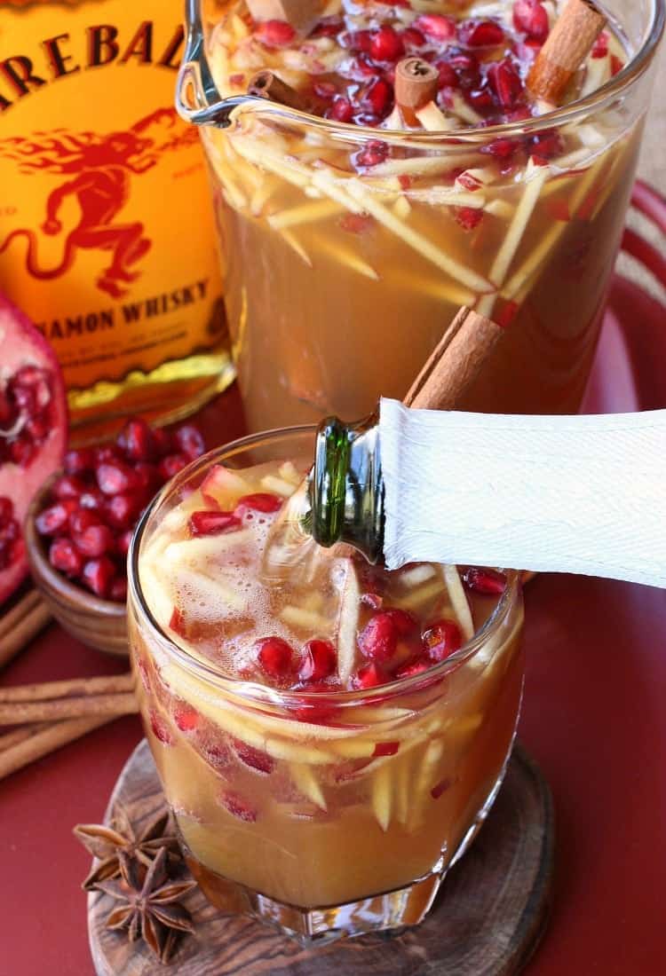 Sparkling Apple Cider Sangria is our favorite fall sangria recipe! Crisp apple cider with a cinnamon kick from Fireball, topped with prosecco! Top off your Sparkling Fireball Apple Sangria with sparkling apple cider or champagne!