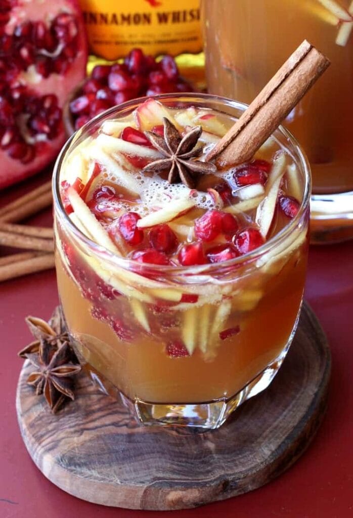 Sparkling Fireball Apple Sangria with a cinnamon stick garnish