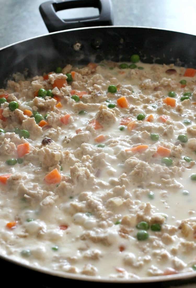 This creamy, Ground Turkey Pasta Sauce is delicious on any type of pasta! Add a buttery, toasted breadcrumb topping for flavor and texture! Turkey cream sauce cooking in a skillet