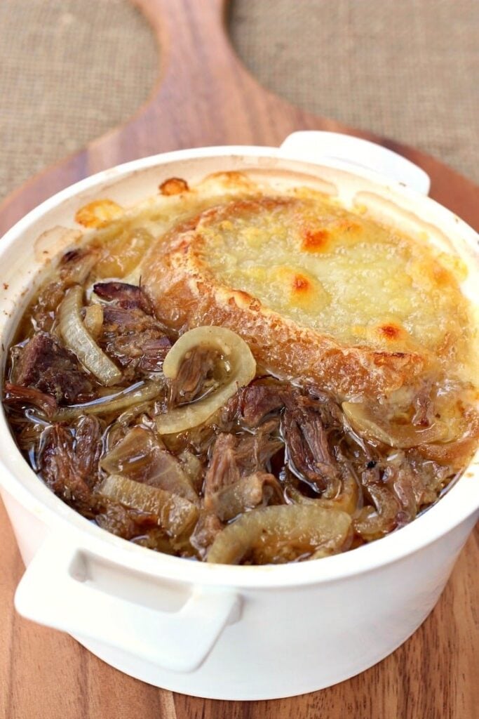 This Slow Cooker Beefy French Onion Soup is loaded with shredded beef and topped with cheese!