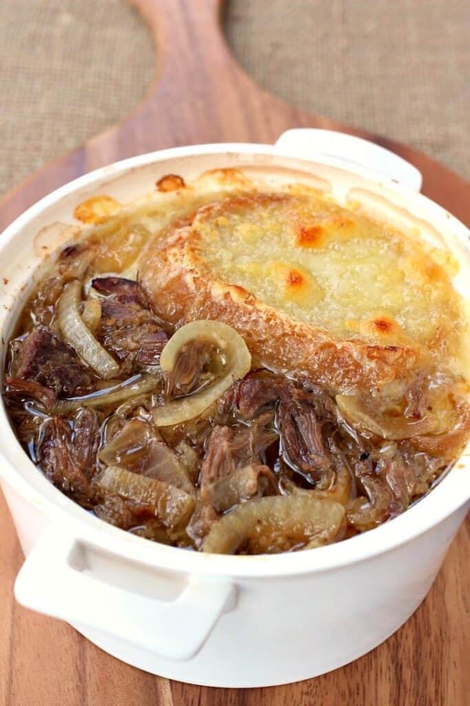 This Slow Cooker Beefy French Onion Soup is loaded with shredded beef and topped with cheese!