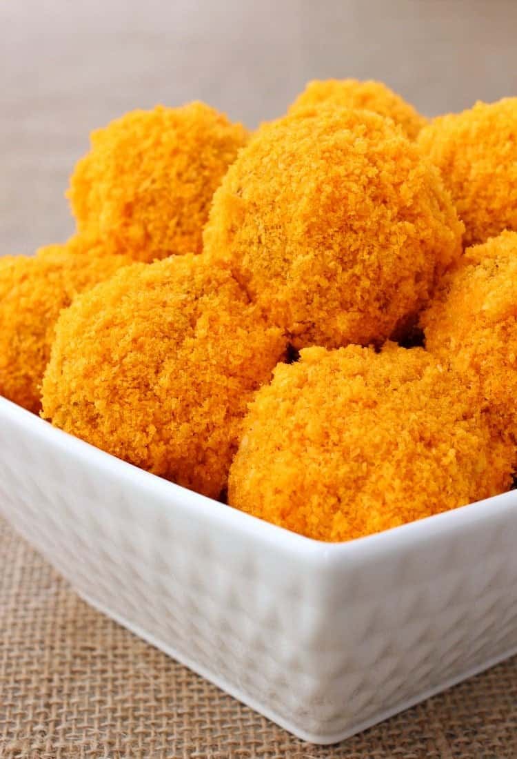 Cheese Doodle Chicken Meatballs are the ultimate party food! Chicken meatballs, stuffed with cheese and bacon with a crunchy cheesy crust! Stuffed Cheese Doodle Meatballs are coated in a cheese doodle crust!