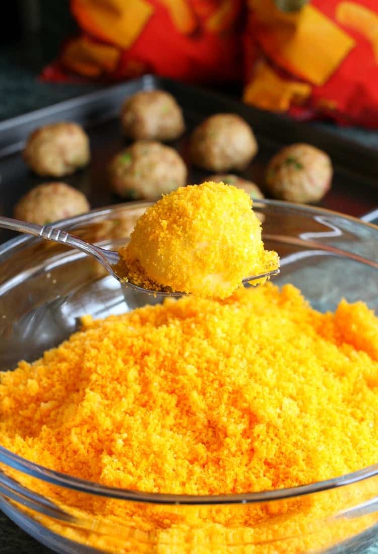 Cheese Doodle Chicken Meatballs are the ultimate party food! Chicken meatballs, stuffed with cheese and bacon with a crunchy cheesy crust! Coat these Stuffed Cheese Doodle Meatballs in cheese doodle coating!
