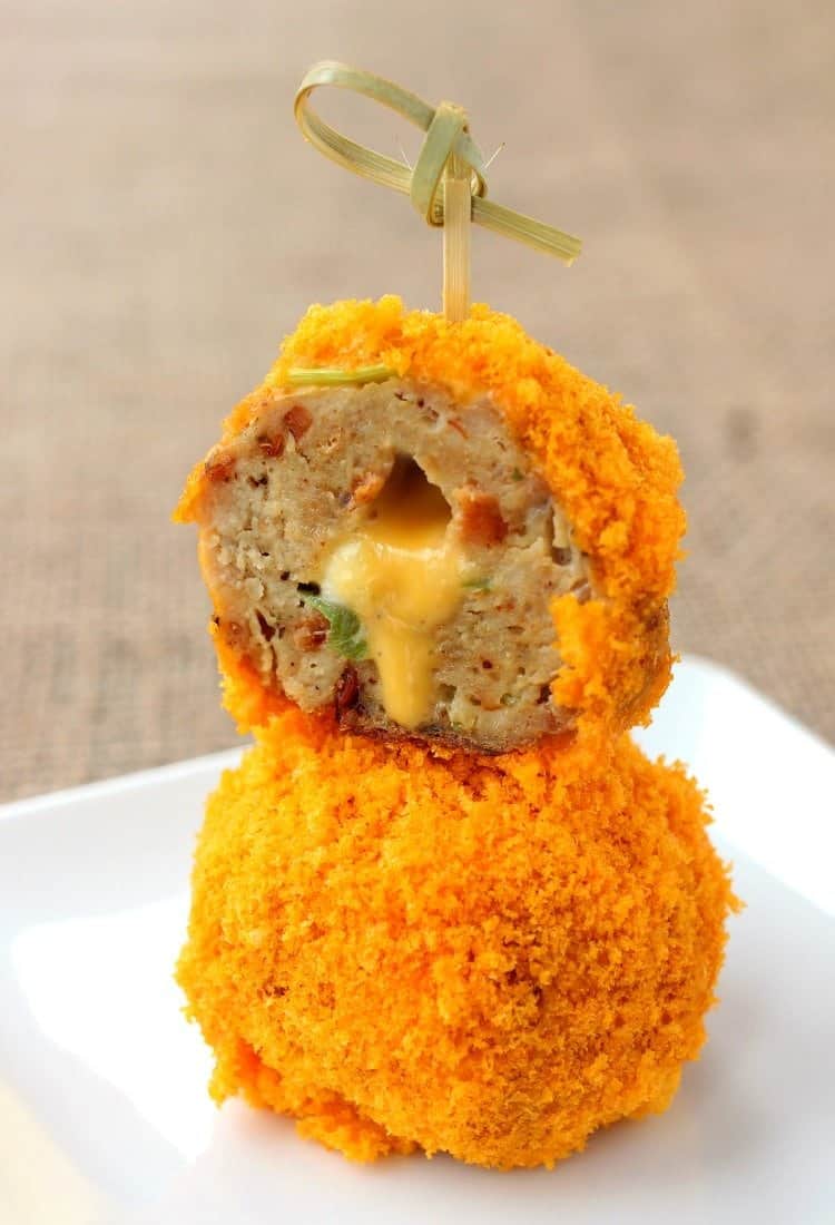 Cheese Doodle Chicken Meatballs are the ultimate party food! Chicken meatballs, stuffed with cheese and bacon with a crunchy cheesy crust! Make these Stuffed Cheese Doodle Meatballs for your next party!