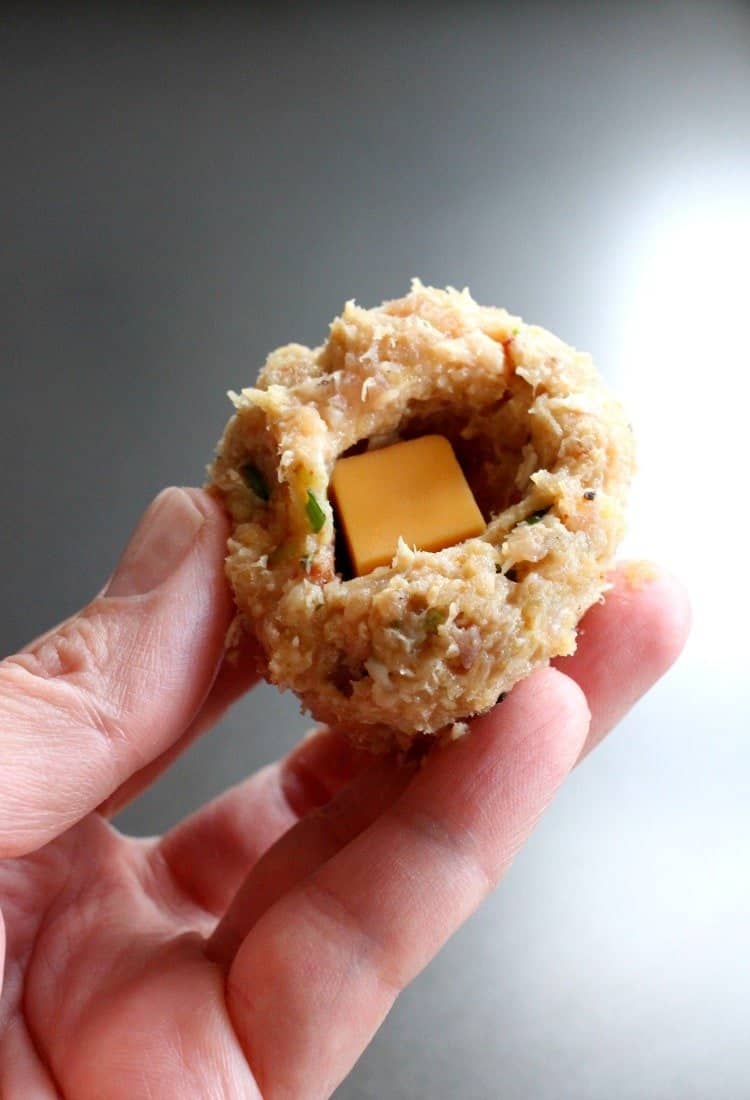 Cheese Doodle Chicken Meatballs are the ultimate party food! Chicken meatballs, stuffed with cheese and bacon with a crunchy cheesy crust! Cheese Doodle Chicken Meatballs are filled with Velveeta cheese!