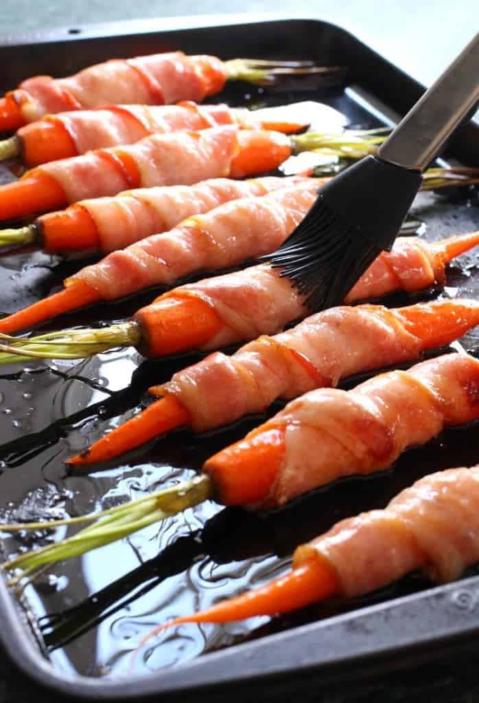 Glaze these Bacon Wrapped Maple Glazed Carrots then roast for an epic side dish!