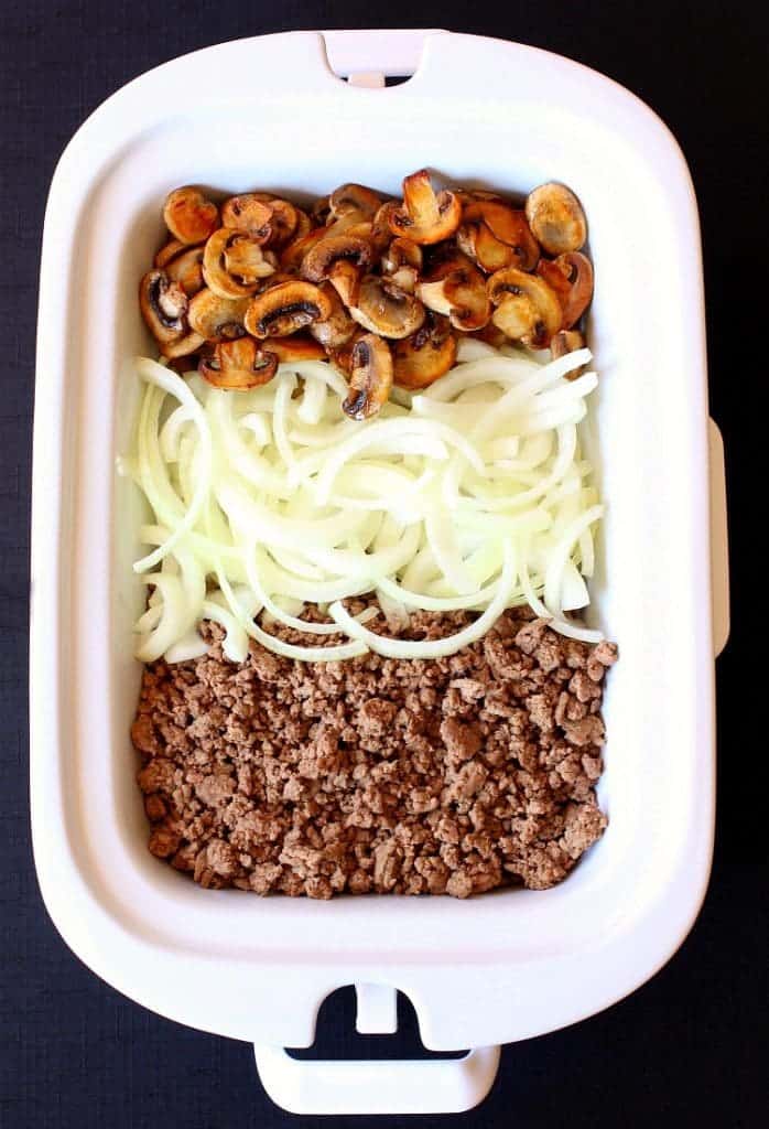 Slow Cooker Cheesy Beef Stroganoff starts out with mushrooms, beef and onions.