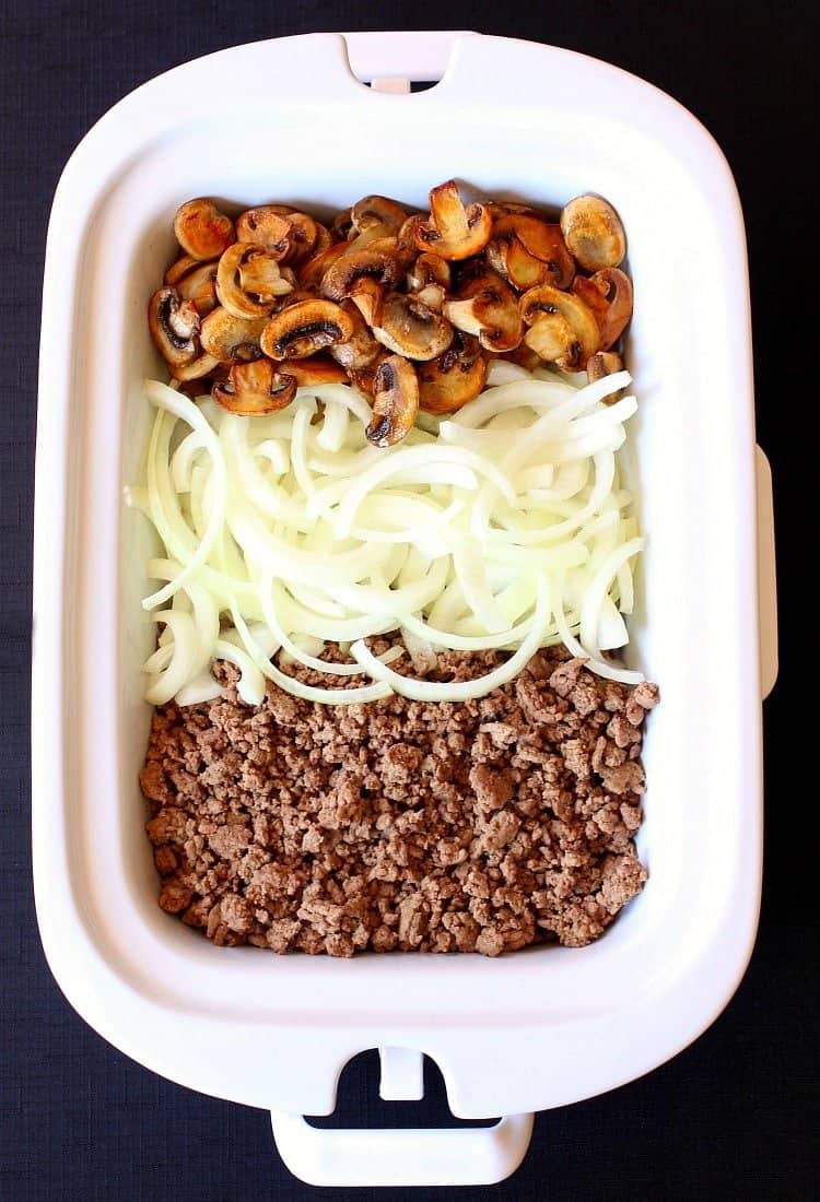 Slow Cooker Beef Stroganoff is loaded with ground beef and mushrooms topped with melted mozzarella just to kick up the comfort food level! Slow Cooker Cheesy Beef Stroganoff starts out with mushrooms, beef and onions.