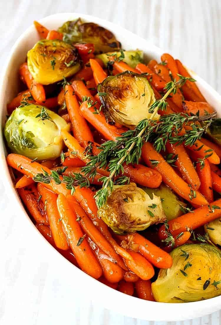 brussels sprouts and carrots with fresh thyme on top