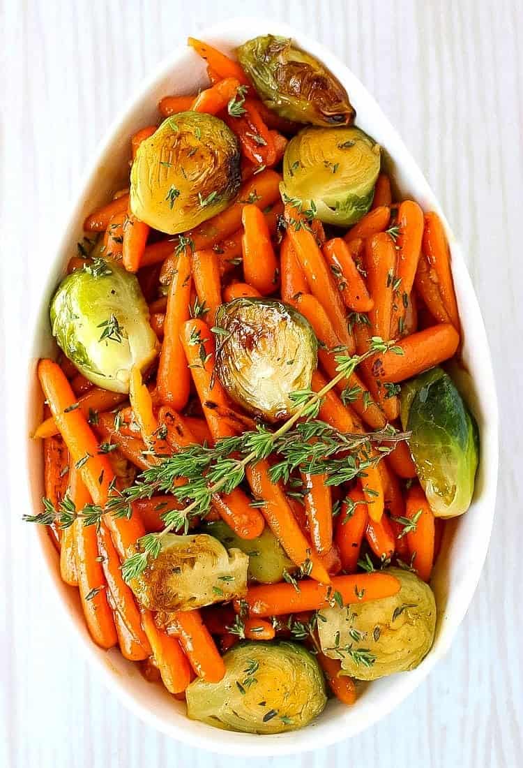 brussels sprouts and carrots in a white dish