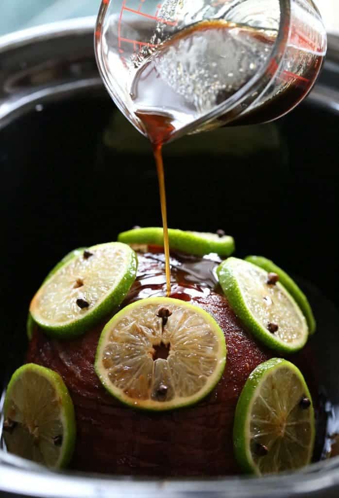 Pour the boozy glaze on top of this Slow Cooker Captain and Coke Glazed Ham!