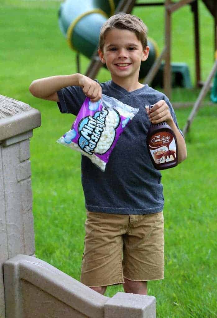 Evan holding marshmallows and syrup