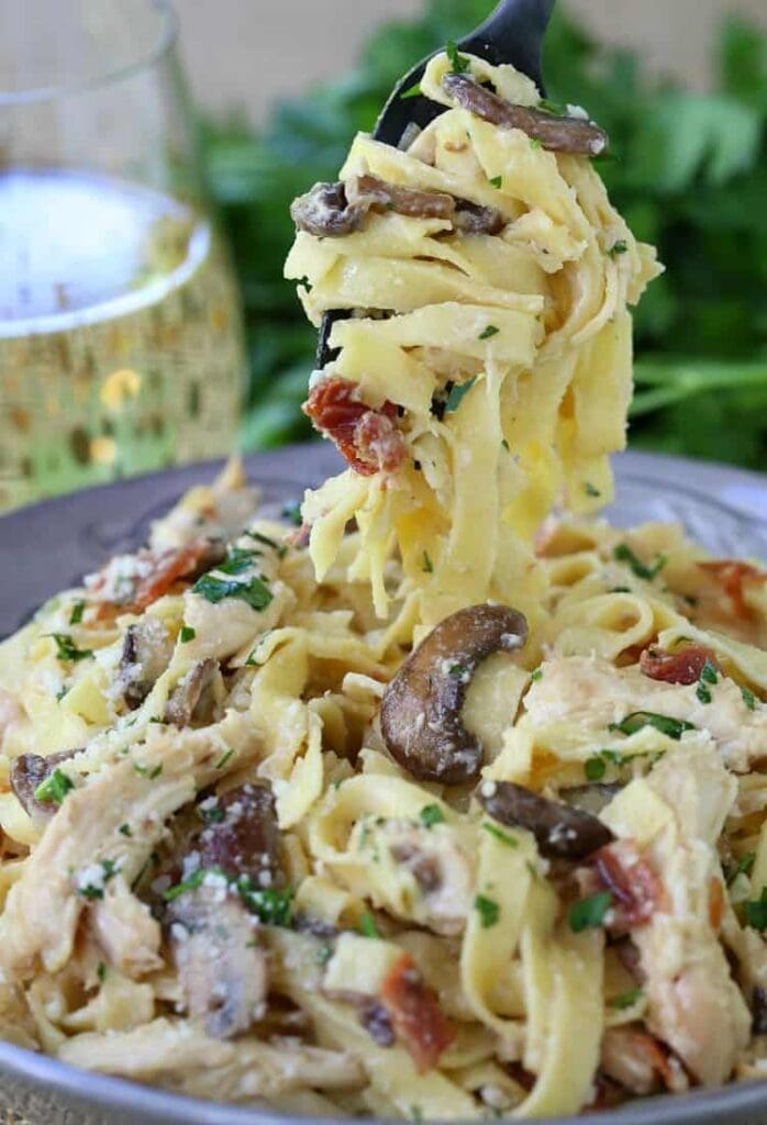 Chicken Marsala Fettuccini Alfredo twisted onto a fork