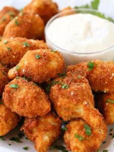 fried artichoke hearts on platter with garlic aioli sauce