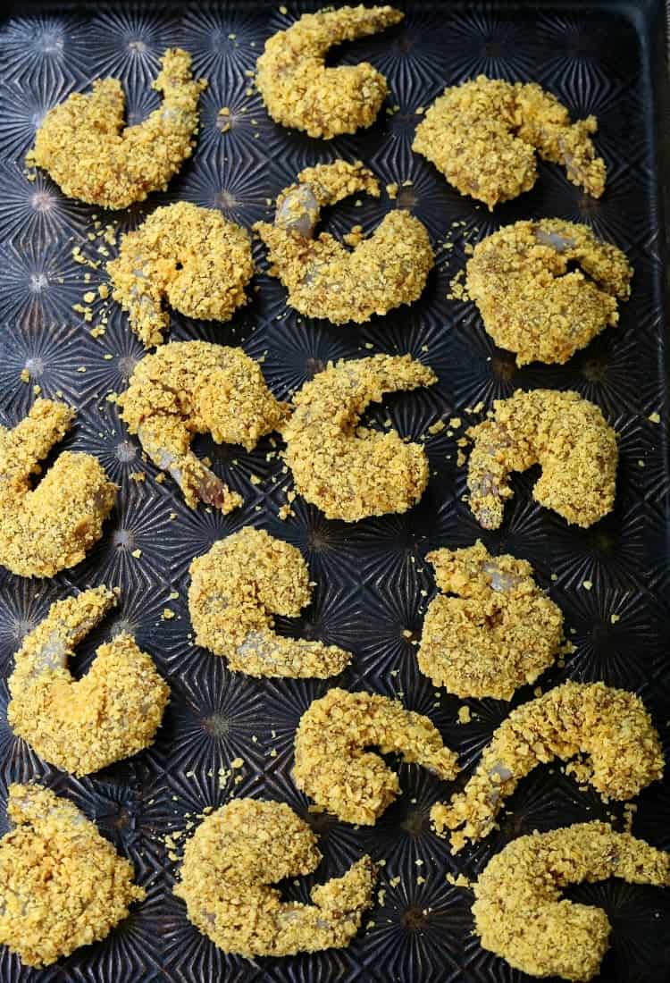 Crunchy Tortilla Shrimp are fun for a tapas night or happy hour! Jumbo shrimp breaded in crushed tortilla chips and baked until crispy! Tortilla Crusted Taco Shrimp breaded on pan