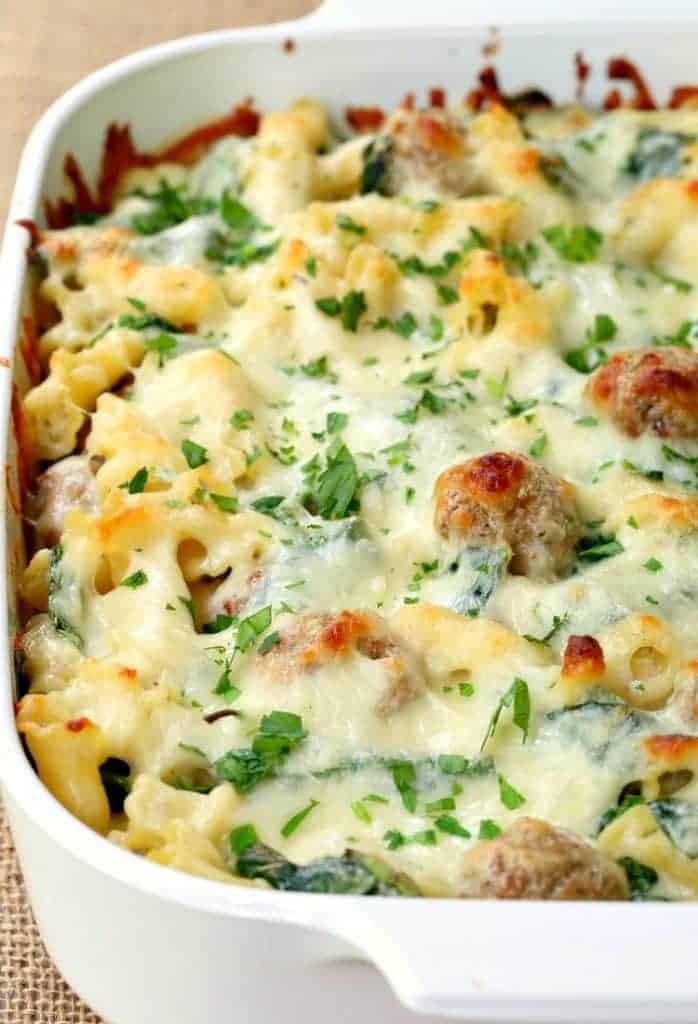 Baked ziti recipe topped with spinach, meatballs and mozzarella cheese