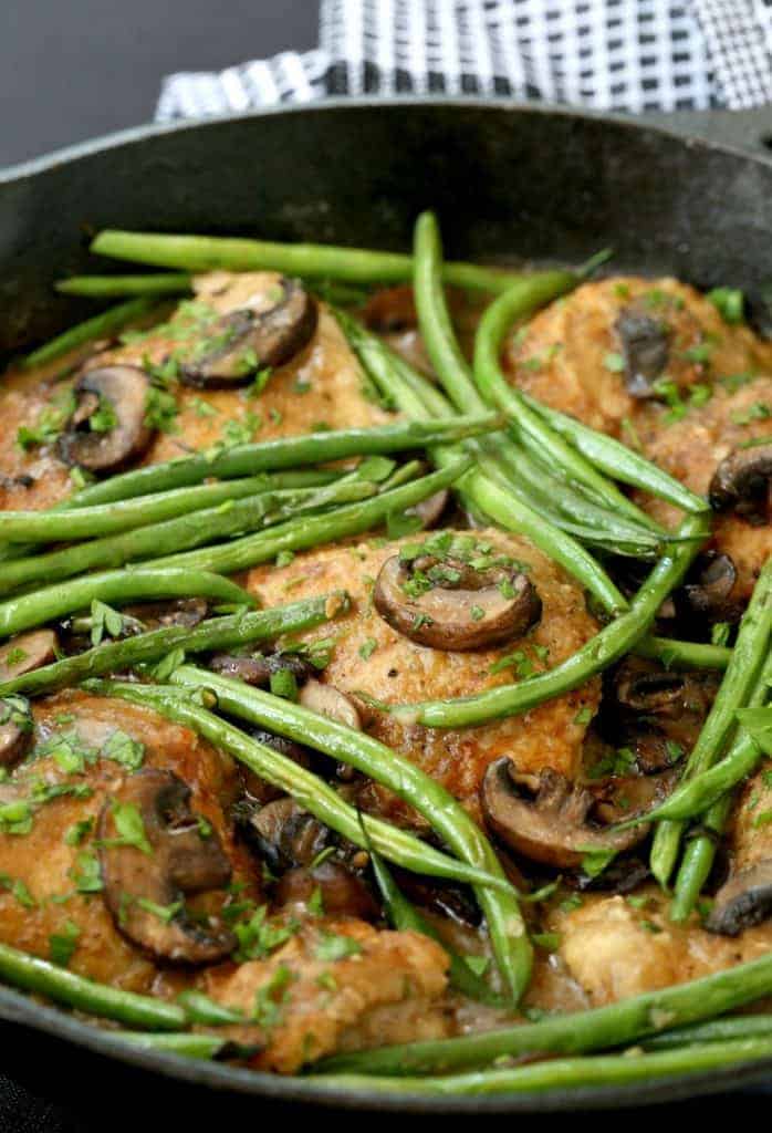 Braised Chicken Thighs and Green Beans in skillet with napkin