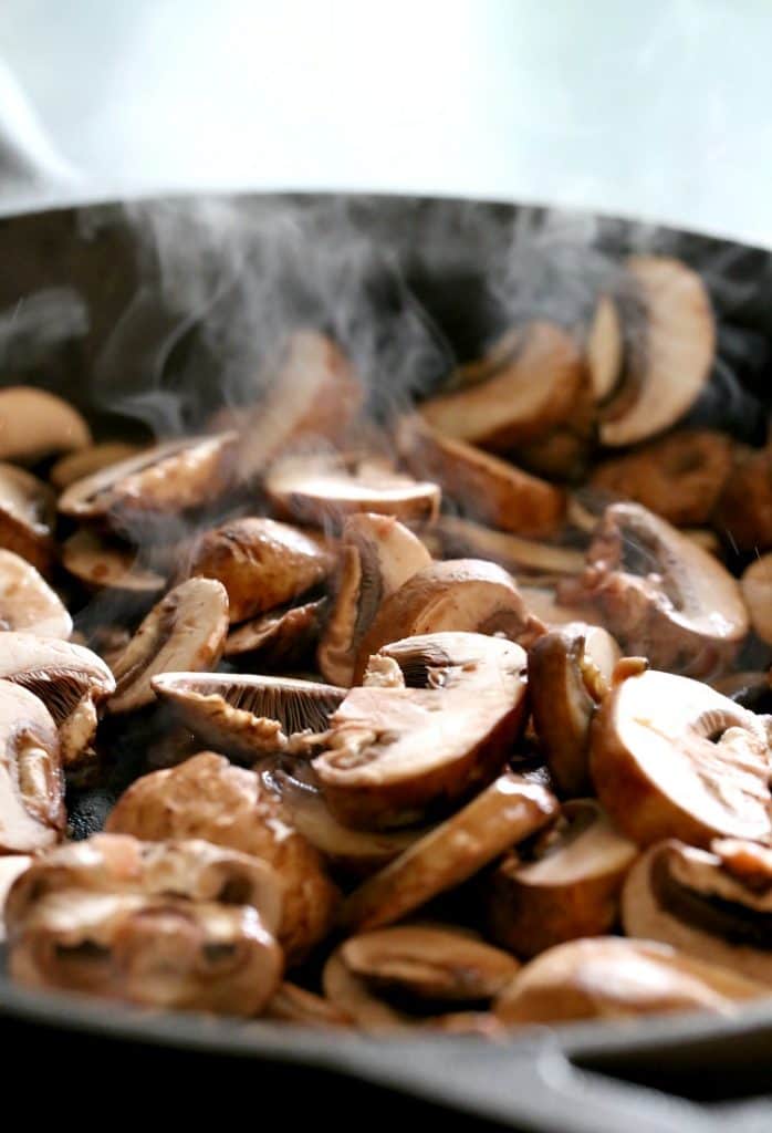 mushrooms cooking in a skillet