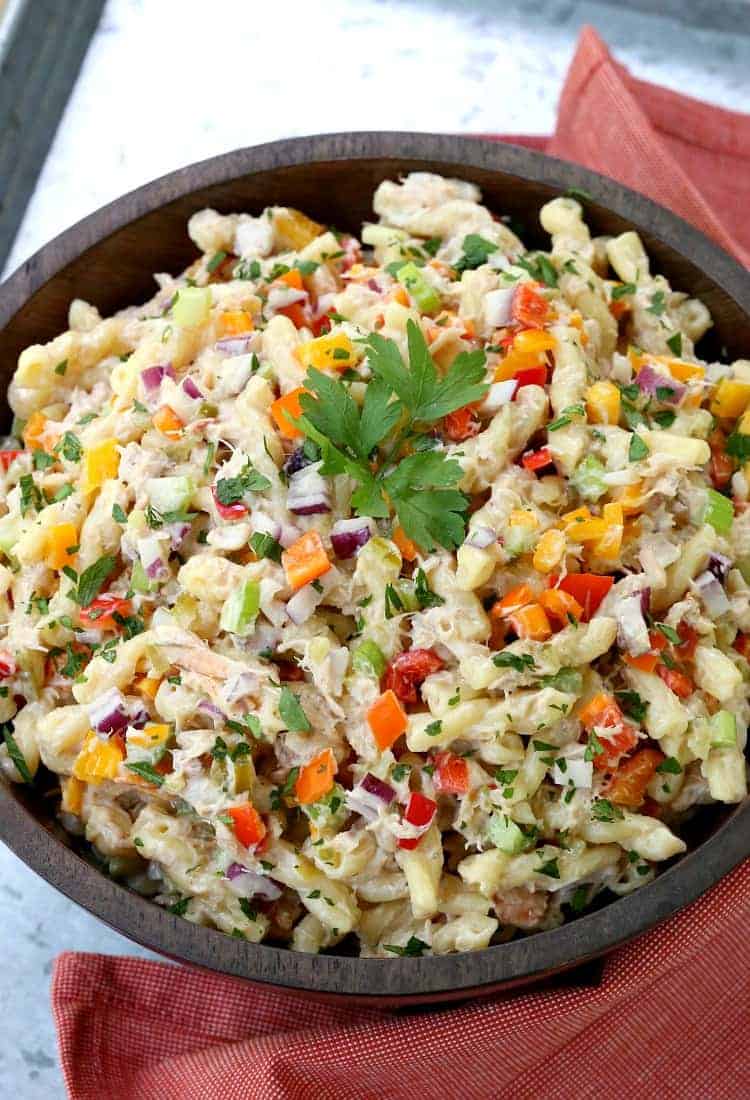 Crab cake pasta salad in a wood bowl with a red napkin