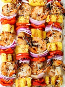 shrimp kabobs with pineapple on a platter