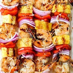 shrimp kabobs with pineapple on a platter