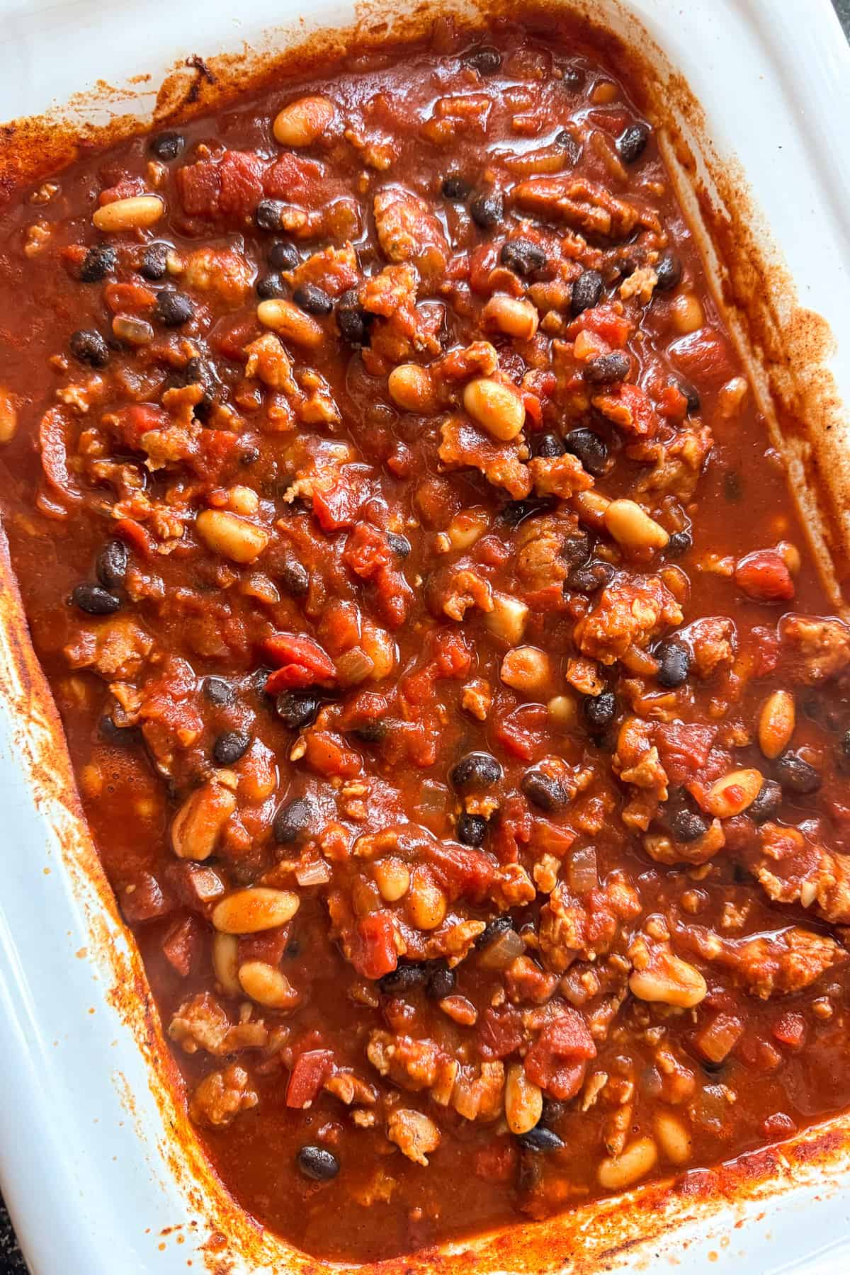 This Chicken Sausage Chili is super hearty and packed with flavor! We like a combo of sweet and spicy sausage, lots of beans and bold spices. sausage chili in slow cooker