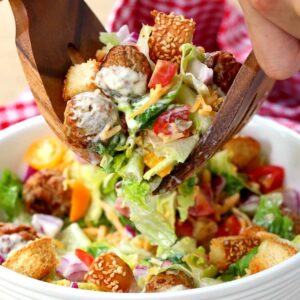 Cheeseburger Salad with tongs