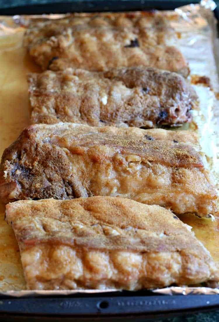 Root Beer BBQ Ribs are crazy addicting and coated in a sweet homemade root beer barbecue sauce. An easy to make, make ahead dinner recipe! Sticky Root Beer BBQ Ribs after 3 hours in the oven.