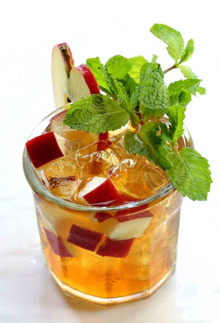 A refreshing Apple Whiskey Iced Tea is perfect for warm Fall days. A classic whiskey iced tea kicked up with apple liquor and fresh apples. This Apple Mint Whiskey Iced Tea is so refreshing!