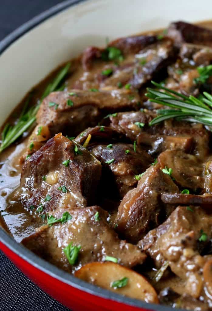 Marsala Wine Beef Stew in a pot with gravy and fresh rosemary
