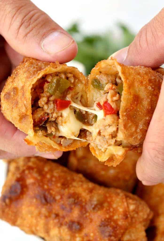 Make these Italian Egg Rolls with sausage, peppers and a crazy cheesy center!