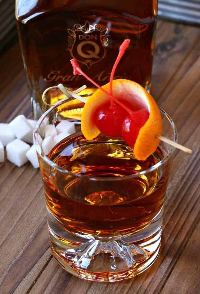 Rum Old Fashioned on board with bottle