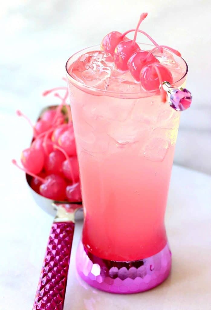 A pink shirley template drink in a tall glass