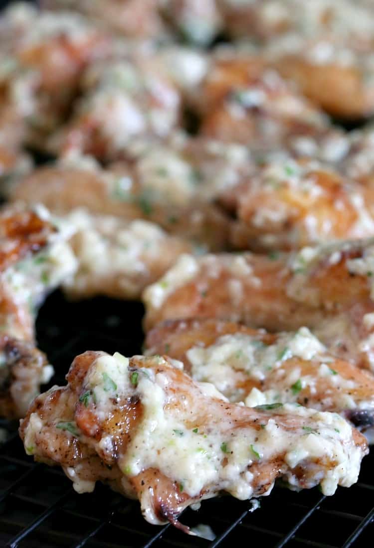 Chicken wings tossed in a garlic parmesan sauce ready to go back into the oven.
