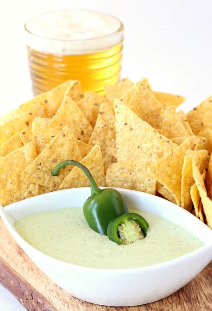Creamy Jalapeño Dip in a white bowl with a pepper garnish