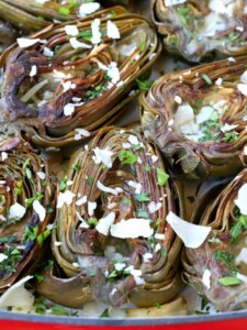 Roasted Artichokes in a baking dish with parmesan cheese