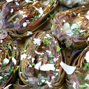 Roasted Artichokes in a baking dish with parmesan cheese