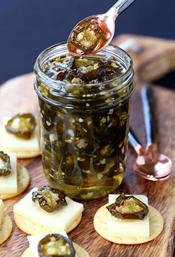 Candied Jalapeños in a jar with crackers