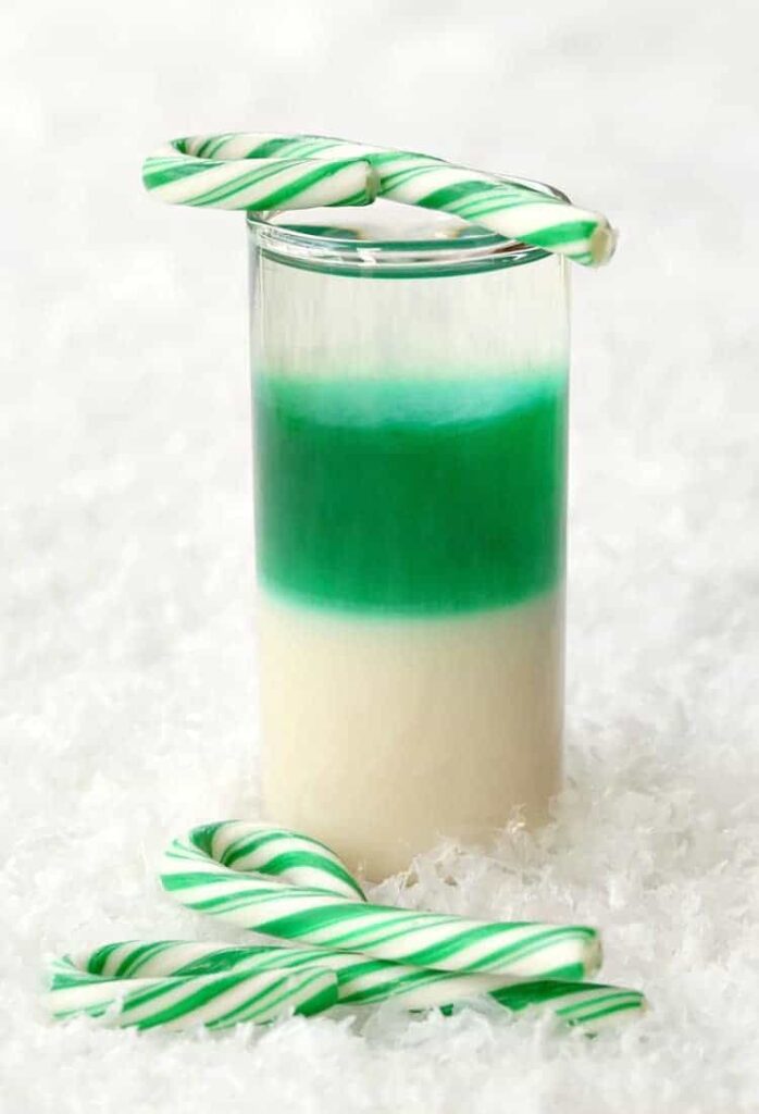 Layered Candy Cane Shots are going to be a hit at your holiday party!