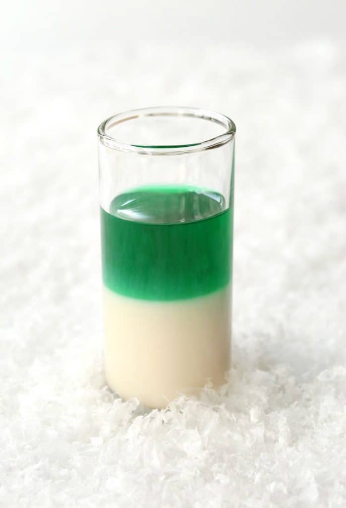 These Layered Candy Cane Shots start off with RumChata and get a layer of mint.